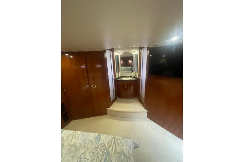 Sea Spirit Yacht Photos Pics Luxurious interior of 2004 Carver 570 Voyager Pilothouse yacht with wood paneling and vanity.