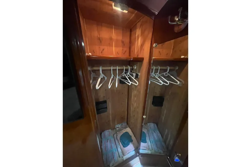 Sea Spirit Yacht Photos Pics Wooden closet interior with hangers in a 2004 Carver 570 Voyager Pilothouse yacht.