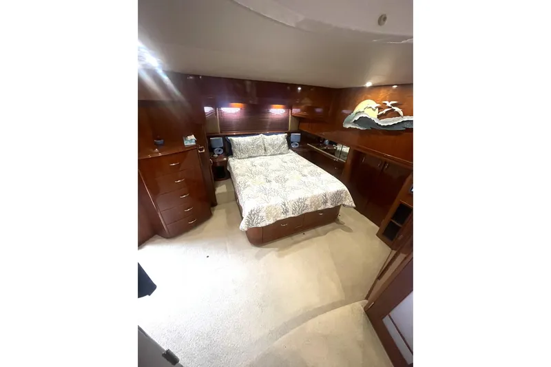 Sea Spirit Yacht Photos Pics Luxurious bedroom interior of 2004 Carver 570 Voyager Pilothouse yacht with elegant wood finish.