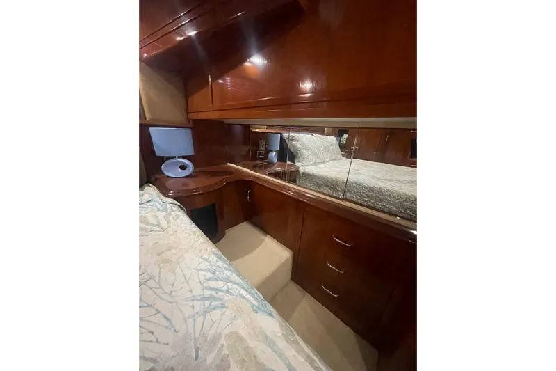 Sea Spirit Yacht Photos Pics Luxurious cabin interior of 2004 Carver 570 Voyager Pilothouse with wood finish and bedding.