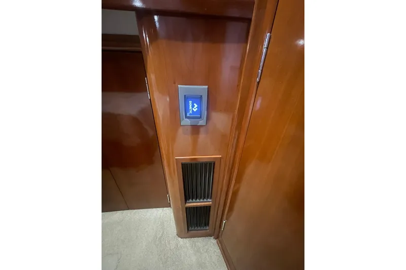 Sea Spirit Yacht Photos Pics Interior of 2004 Carver 570 Voyager Pilothouse with control panel and wooden finish.