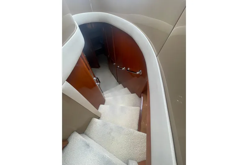 Sea Spirit Yacht Photos Pics Staircase inside 2004 Carver 570 Voyager Pilothouse yacht with wooden paneling and carpeted steps.