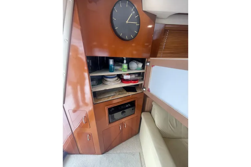 Sea Spirit Yacht Photos Pics Interior of 2004 Carver 570 Voyager Pilothouse with wooden cabinetry and clock.