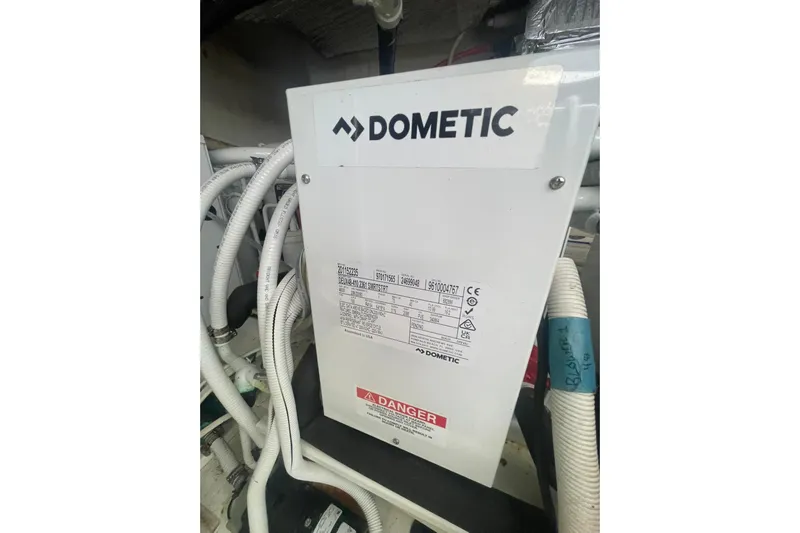 Sea Spirit Yacht Photos Pics Dometic unit in 2004 Carver 570 Voyager Pilothouse engine room with cables and warning label.