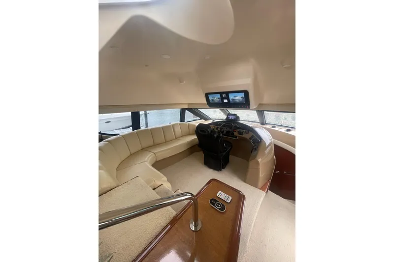 Sea Spirit Yacht Photos Pics Luxurious interior of 2004 Carver 570 Voyager Pilothouse with plush seating and modern helm.