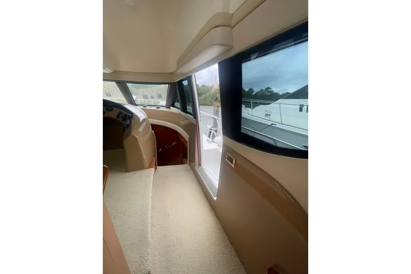 Sea Spirit Yacht Photos Pics Interior view of 2004 Carver 570 Voyager Pilothouse, featuring helm and large windows.