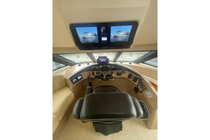 Sea Spirit Yacht Photos Pics Pilothouse interior of 2004 Carver 570 Voyager, featuring modern navigation displays and controls.