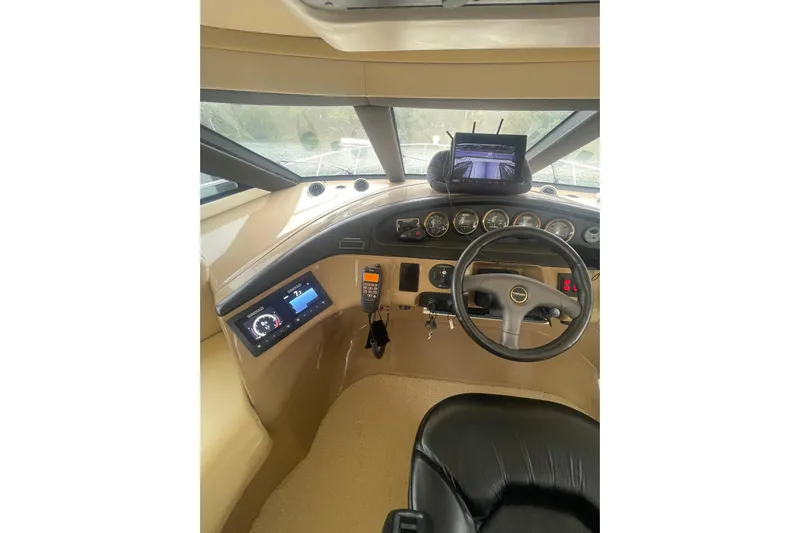 Sea Spirit Yacht Photos Pics Pilothouse interior of 2004 Carver 570 Voyager, featuring steering wheel and navigation instruments.