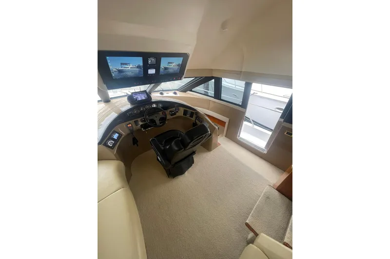 Sea Spirit Yacht Photos Pics Pilothouse interior of 2004 Carver 570 Voyager, featuring modern navigation displays and controls.