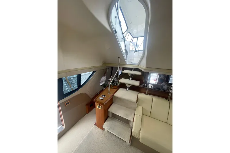 Sea Spirit Yacht Photos Pics Interior of 2004 Carver 570 Voyager Pilothouse with stairs and seating area.