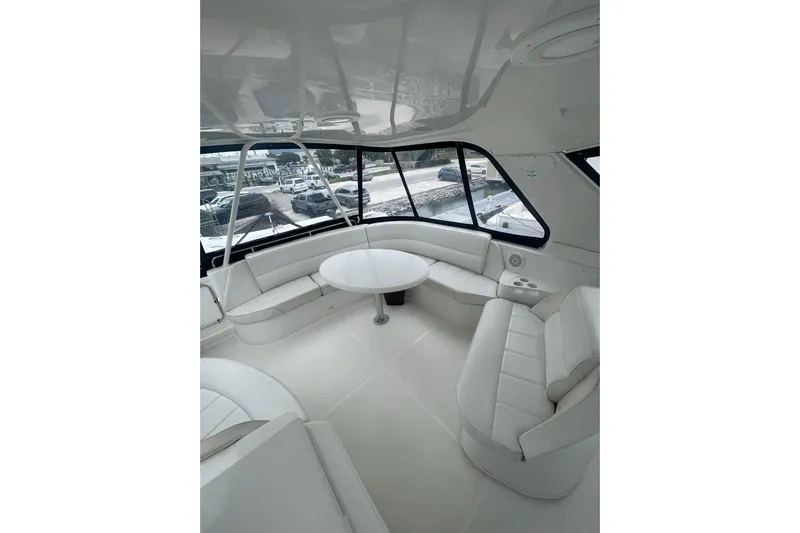Sea Spirit Yacht Photos Pics Luxurious interior of 2004 Carver 570 Voyager Pilothouse with white seating and round table.