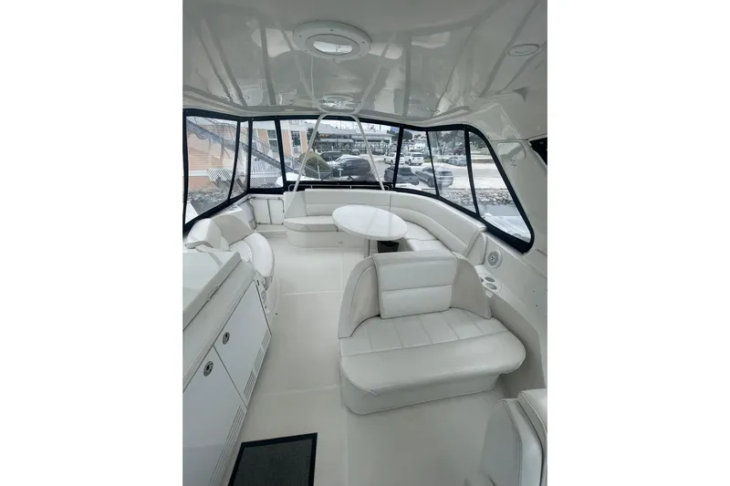 Sea Spirit Yacht Photos Pics Interior of 2004 Carver 570 Voyager Pilothouse with white seating and panoramic windows.