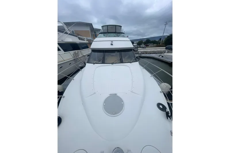Sea Spirit Yacht Photos Pics 2004 Carver 570 Voyager Pilothouse yacht docked at marina under cloudy sky.