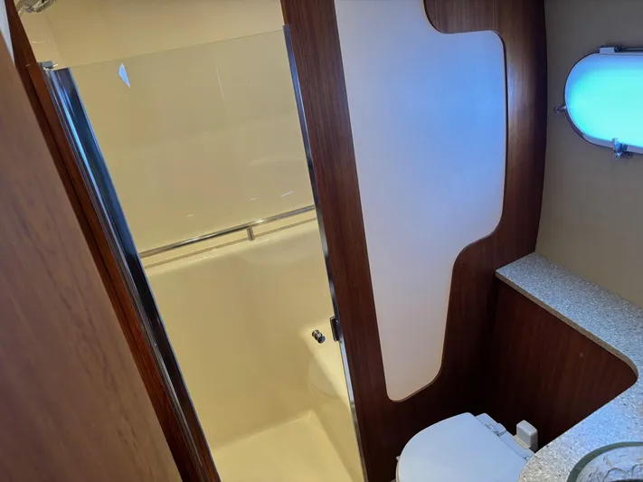 Cruise Prop Too Yacht Photos Pics 2010 Tiara Yachts 3900 Sovran bathroom with modern design and wooden accents.