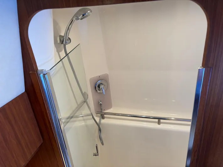 Cruise Prop Too Yacht Photos Pics Shower area in 2010 Tiara Yachts 3900 Sovran, featuring modern fixtures and glass door.