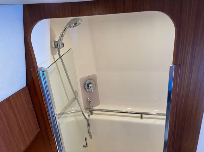 Cruise Prop Too Yacht Photos Pics Shower area in 2010 Tiara Yachts 3900 Sovran with wood accents and glass door.