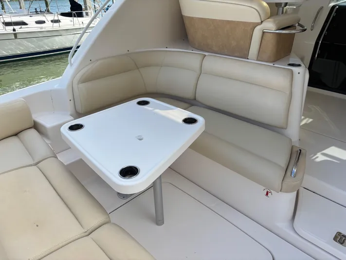 Cruise Prop Too Yacht Photos Pics 2010 Tiara Yachts 3900 Sovran interior with beige seating and white table.