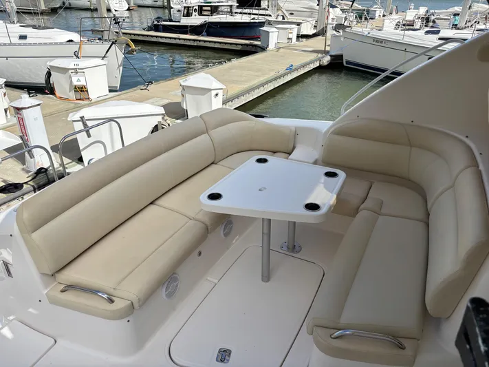 Cruise Prop Too Yacht Photos Pics 2010 Tiara Yachts 3900 Sovran cockpit with beige seating and table at marina.