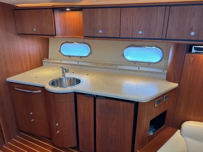 Cruise Prop Too Yacht Photos Pics 2010 Tiara Yachts 3900 Sovran interior kitchen with wood cabinets and countertop.