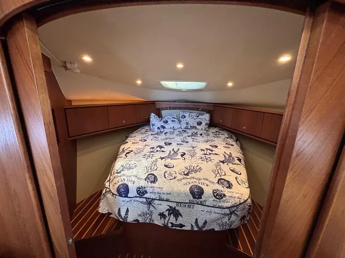Cruise Prop Too Yacht Photos Pics Cozy cabin interior of 2010 Tiara Yachts 3900 Sovran with nautical-themed bedding.