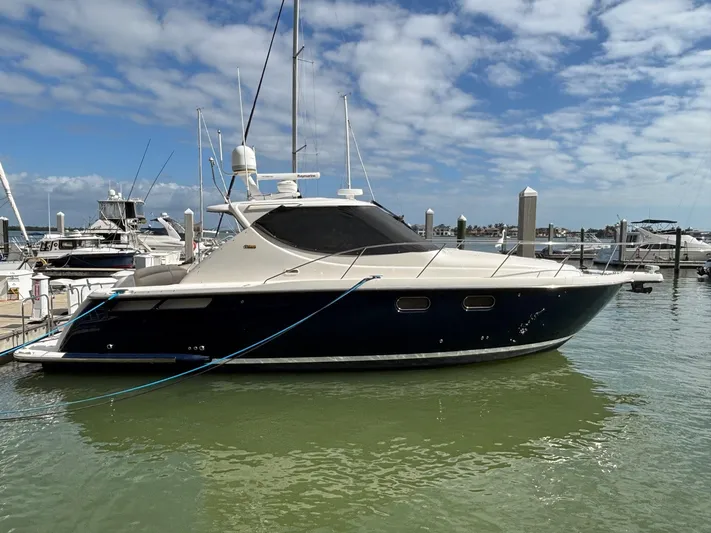 Cruise Prop Too Yacht Photos Pics 2010 Tiara Yachts 3900 Sovran docked in a marina under a partly cloudy sky.