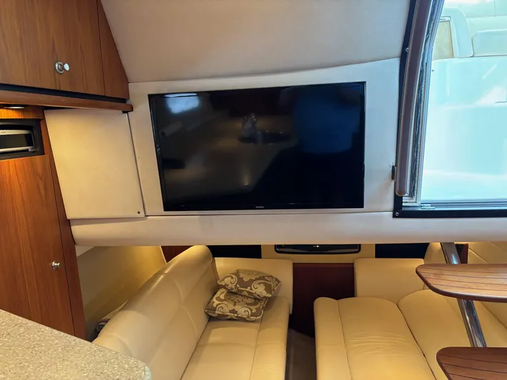 Cruise Prop Too Yacht Photos Pics Interior of 2010 Tiara Yachts 3900 Sovran with TV and beige seating area.