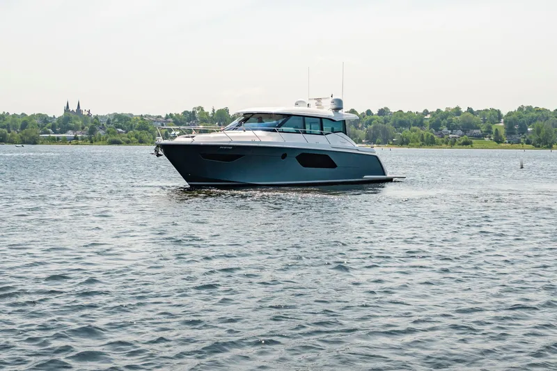  Yacht Photos Pics 2019 Tiara Yachts C49 Coupe cruising on a serene lake.