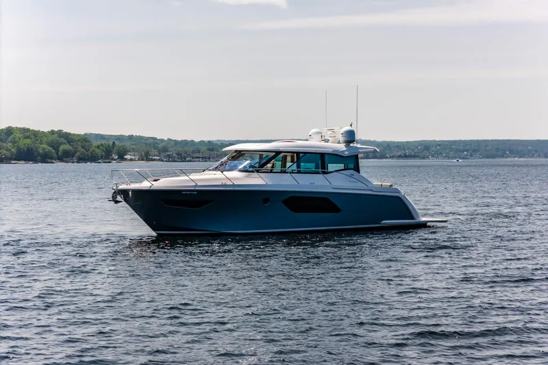  Yacht Photos Pics 2019 Tiara Yachts C49 Coupe cruising on a serene lake.