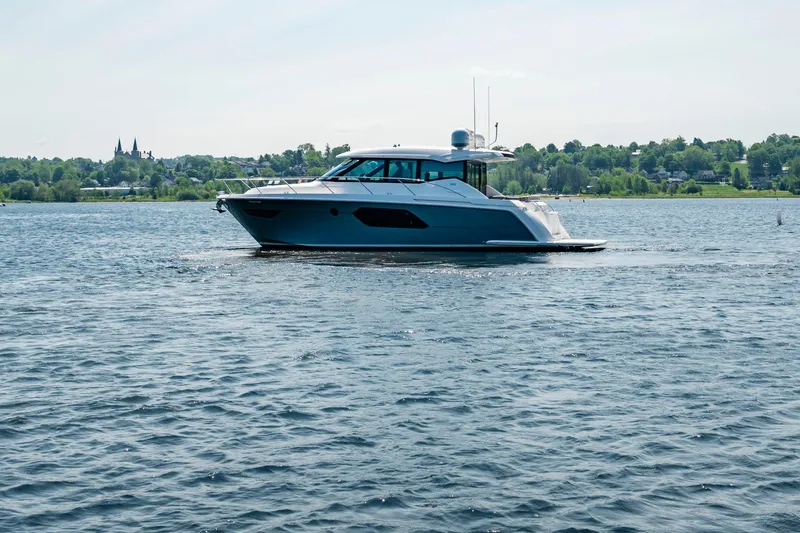  Yacht Photos Pics 2019 Tiara Yachts C49 Coupe cruising on a serene lake.