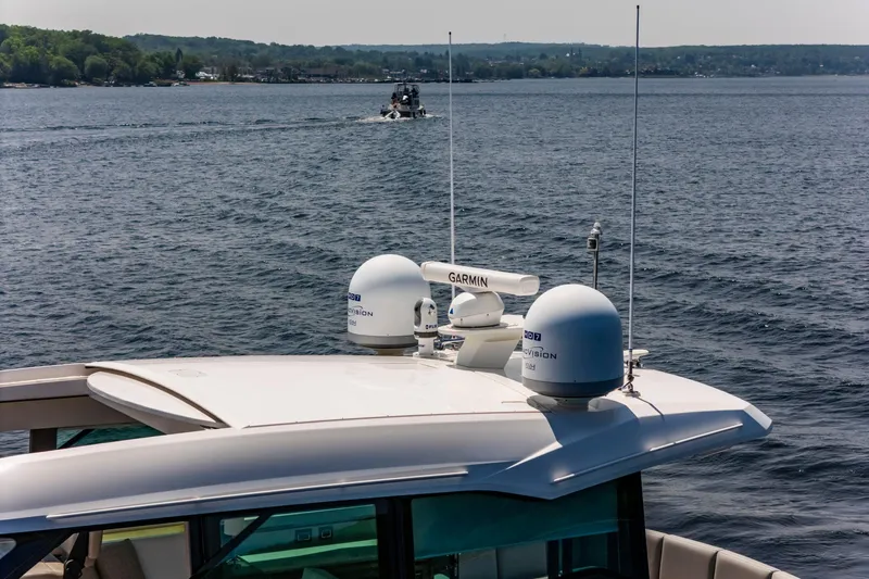  Yacht Photos Pics 2019 Tiara Yachts C49 Coupe on water, featuring advanced navigation equipment.