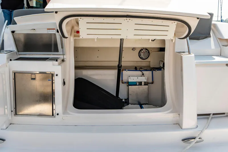  Yacht Photos Pics 2019 Tiara Yachts C49 Coupe storage compartment with equipment and stainless steel door.