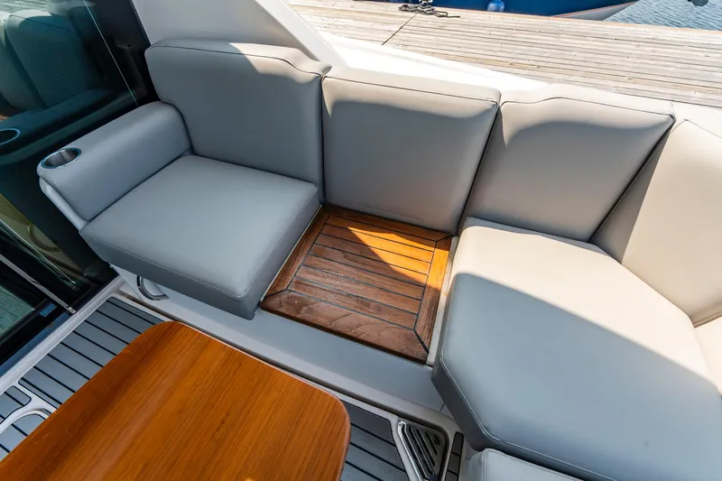  Yacht Photos Pics Luxurious seating area on 2019 Tiara Yachts C49 Coupe with wooden accents.