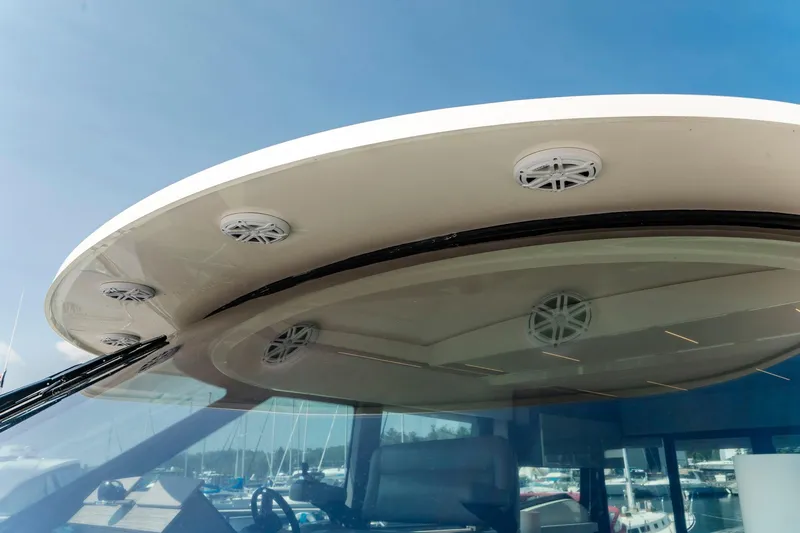  Yacht Photos Pics 2019 Tiara Yachts C49 Coupe roof with speakers, marina background.