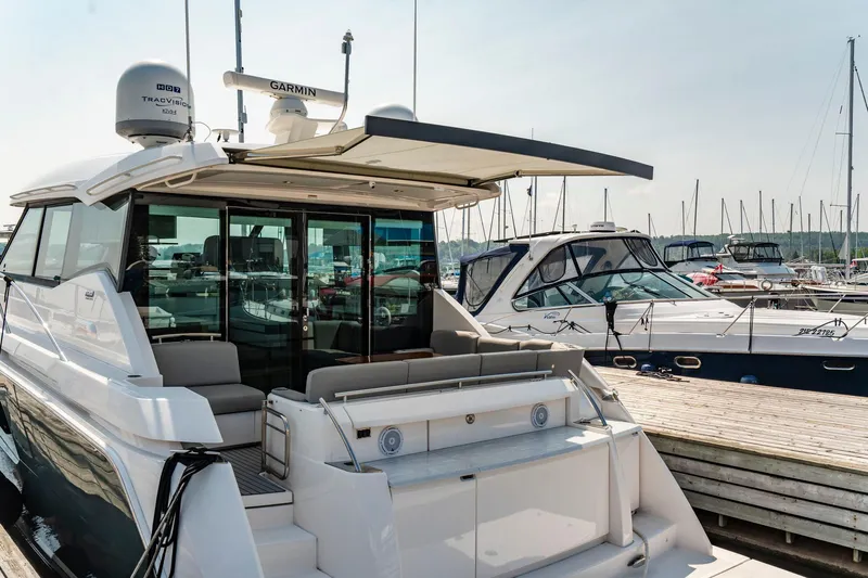  Yacht Photos Pics 2019 Tiara Yachts C49 Coupe docked at marina, showcasing sleek design and luxury features.