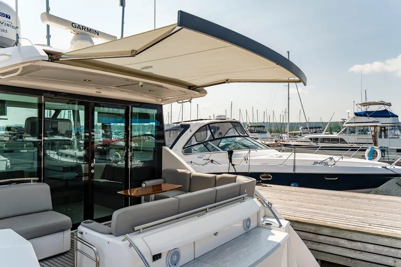 Yacht Photos Pics 2019 Tiara Yachts C49 Coupe docked, featuring spacious deck and modern design.