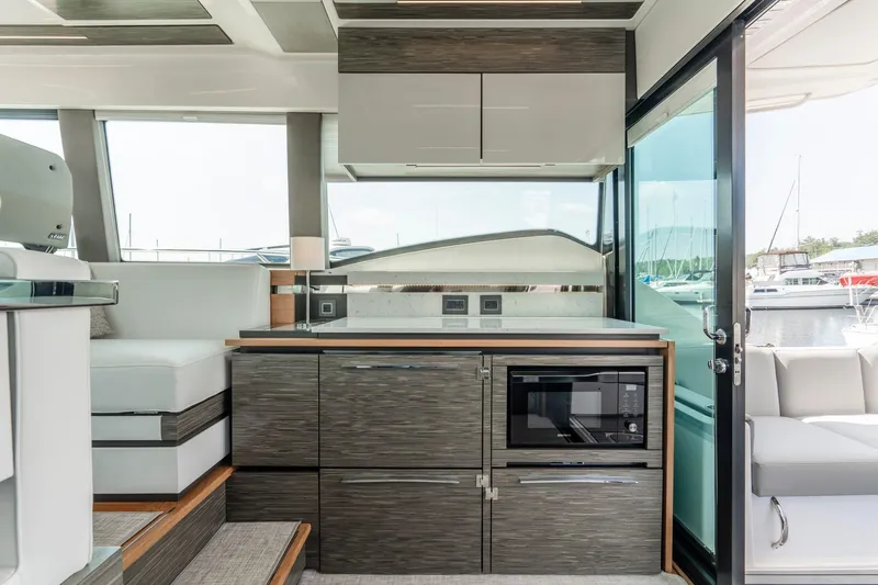  Yacht Photos Pics Modern interior of 2019 Tiara Yachts C49 Coupe with sleek kitchen design.