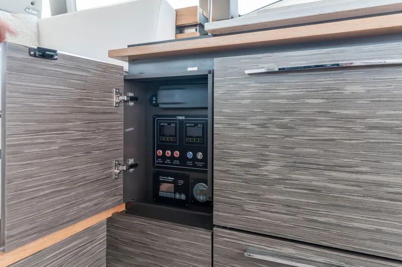  Yacht Photos Pics 2019 Tiara Yachts C49 Coupe electrical panel in sleek wooden cabinet.
