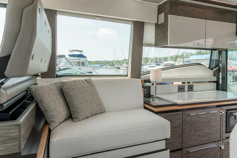  Yacht Photos Pics Interior of 2019 Tiara Yachts C49 Coupe, featuring modern seating and sleek cabinetry.