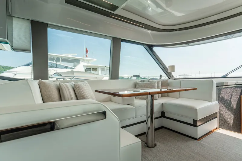  Yacht Photos Pics Luxurious interior of 2019 Tiara Yachts C49 Coupe with elegant seating and panoramic windows.