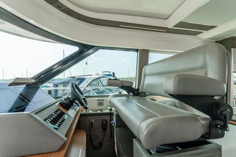  Yacht Photos Pics 2019 Tiara Yachts C49 Coupe helm with modern controls and comfortable seating.