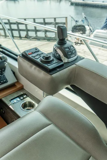  Yacht Photos Pics 2019 Tiara Yachts C49 Coupe helm controls with joystick and cup holder.
