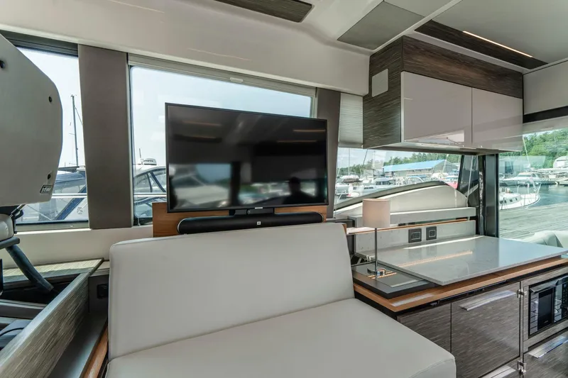  Yacht Photos Pics Interior of 2019 Tiara Yachts C49 Coupe with modern kitchen and seating area.
