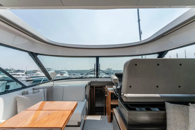  Yacht Photos Pics Interior view of 2019 Tiara Yachts C49 Coupe, featuring luxurious seating and panoramic windows.