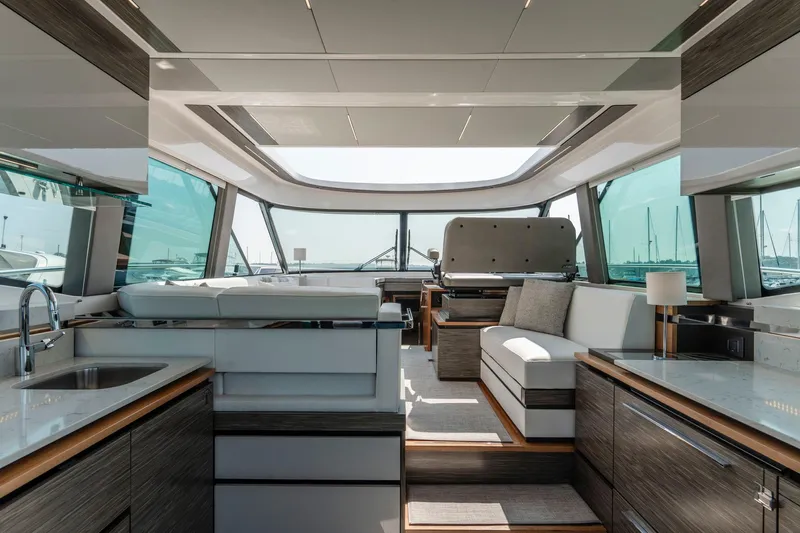  Yacht Photos Pics Luxurious interior of 2019 Tiara Yachts C49 Coupe with modern furnishings and panoramic windows.