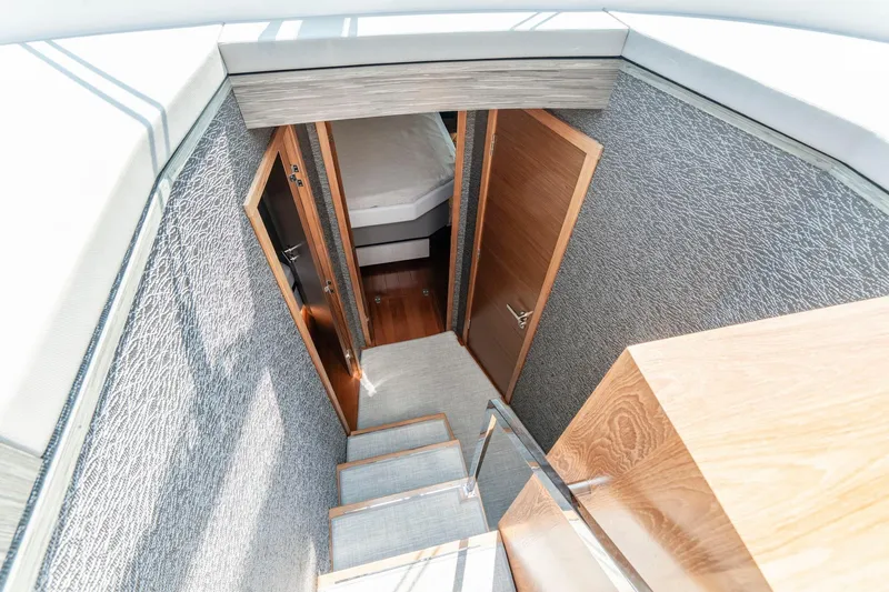  Yacht Photos Pics Stairway leading to cabin interior of 2019 Tiara Yachts C49 Coupe.