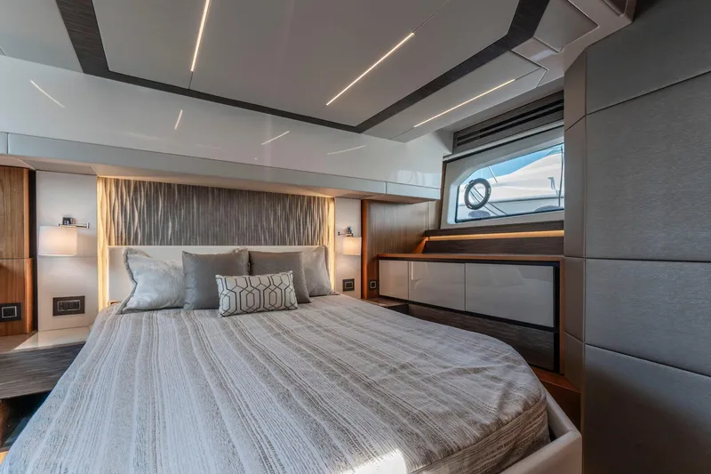  Yacht Photos Pics Luxurious bedroom interior of 2019 Tiara Yachts C49 Coupe with modern design and elegant lighting.