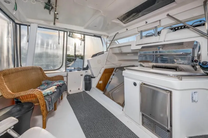  Yacht Photos Pics 1998 Silverton 372 Motor Yacht interior with wicker seating and stainless steel grill.