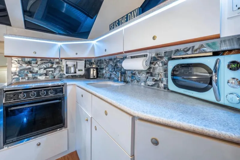  Yacht Photos Pics Modern kitchen in 1998 Silverton 372 Motor Yacht with sleek appliances and stylish backsplash.