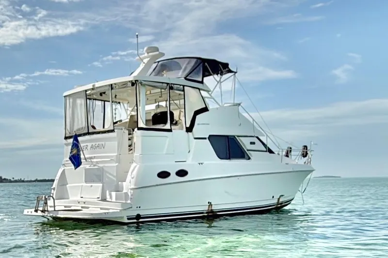  Yacht Photos Pics 1998 Silverton 372 Motor Yacht on calm waters under a clear sky.
