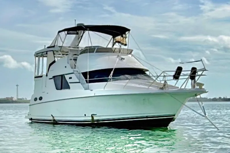  Yacht Photos Pics 1998 Silverton 372 Motor Yacht on calm water under a cloudy sky.